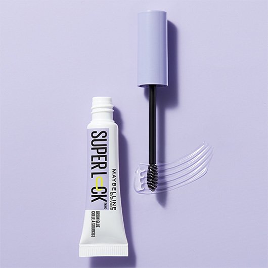 Tube MAYBELLINE Superlock Brow Glue Augenbrauengel mit Applikator auf einem hell-lila Hintergrund. 